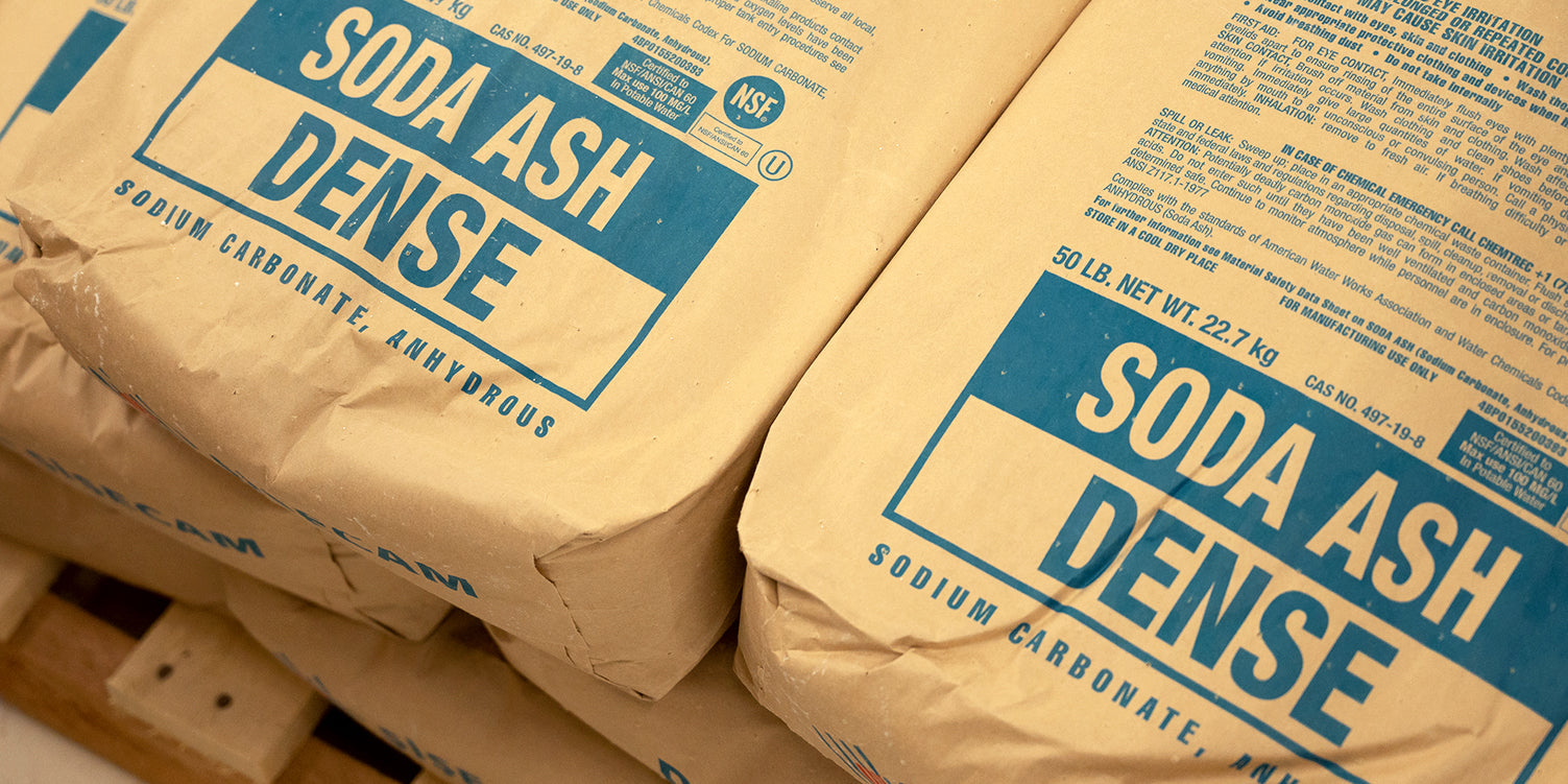 A photo of bags of soda ash stacked on a pallet.