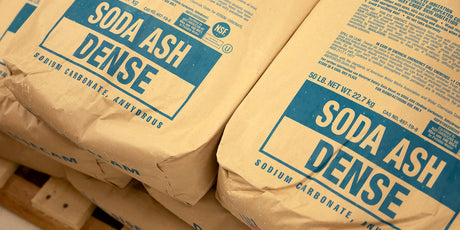 A photo of bags of soda ash stacked on a pallet.