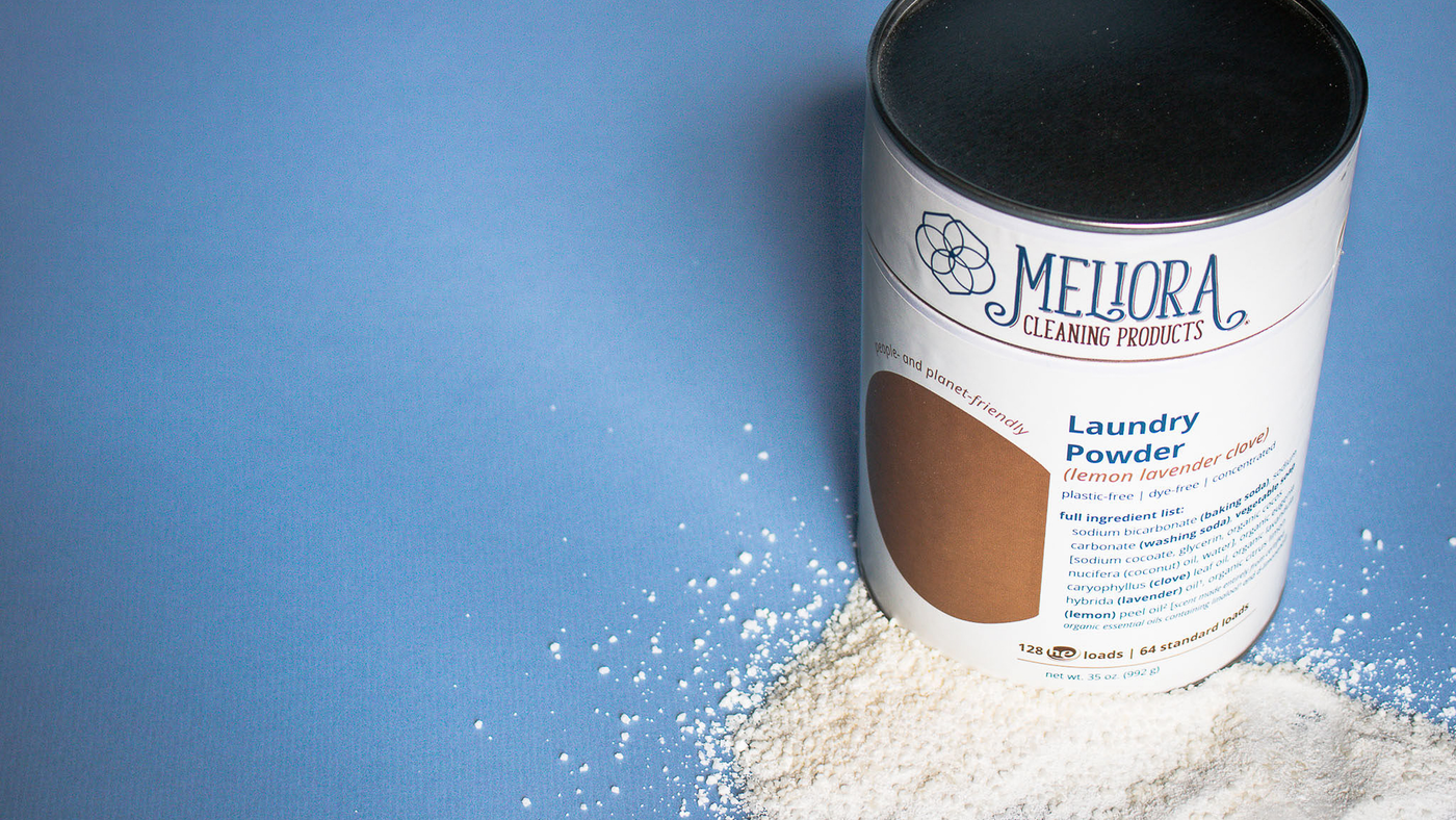 A Meliora Cleaning Products laundry powder can on a blue background.